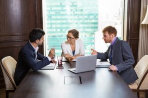 business-woman-talking-with-two-businessmen_1262-806
